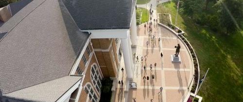 Aerial view of students near campus library with large sidewalks and statue of Abraham Lincoln